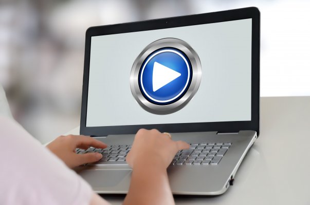 typing on laptop vpn services play button on screen streaming 
